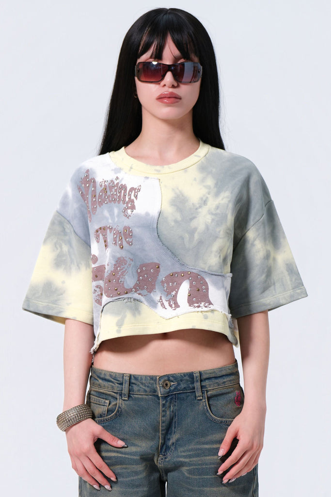 Person wearing a graphic t-shirt and jeans on a white background