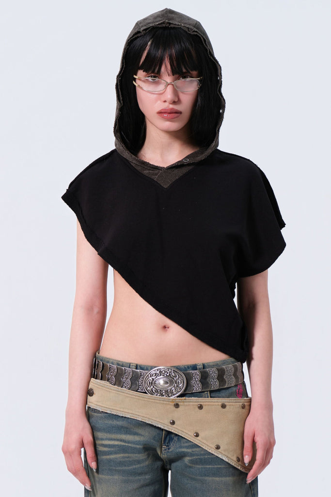 Person wearing a black top and blue jeans with a belt on a white background