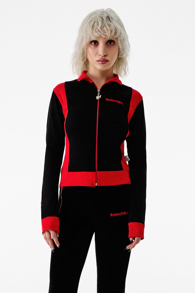 Person wearing a black and red tracksuit on a white background